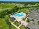 Aerial view of community pool with lounge chairs, sunshades and clubhouse surrounded by lush landscaping at 258 Cherrytree Dr, Fort Mill, SC 29715