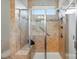 Walk-in shower features neutral tile, a built-in seat and a sliding glass door at 258 Cherrytree Dr, Fort Mill, SC 29715