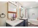 Bathroom features dual sinks with vanities, decorative mirrors, and shower/tub combo at 2843 Startown Rd, Lincolnton, NC 28092
