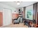 Functional bedroom with custom shelving, ceiling fan, and a large window at 2843 Startown Rd, Lincolnton, NC 28092