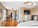 Bright bedroom with wood floors, a ceiling fan, TV, and built in storage, all adding to a comfortable, modern design at 2843 Startown Rd, Lincolnton, NC 28092