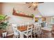 Inviting dining room featuring wood table, white chairs, shelf decor, and view of the kitchen at 2843 Startown Rd, Lincolnton, NC 28092