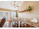 Bright dining area with a wooden table, white chairs, a wooden shelf, and a view of the outdoors at 2843 Startown Rd, Lincolnton, NC 28092