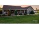 Inviting home featuring a covered front porch and lush landscaping, creating a welcoming curb appeal at 2843 Startown Rd, Lincolnton, NC 28092