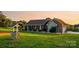 Charming brick home featuring a stone facade, well-maintained lawn, and a decorative wishing well feature at 2843 Startown Rd, Lincolnton, NC 28092