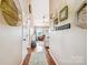 Inviting hallway with wood floors, decorative wall decor, and an open view into the living area at 2843 Startown Rd, Lincolnton, NC 28092
