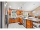 Spacious kitchen with stainless steel refrigerator, tile flooring, wood cabinets, and plenty of counter space at 2843 Startown Rd, Lincolnton, NC 28092