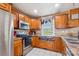 Well-equipped kitchen with stainless steel appliances, wooden cabinets, and a cozy window view at 2843 Startown Rd, Lincolnton, NC 28092