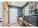 Modern laundry room with front load washer/dryer, cabinets, countertops, storage and stylish wood accent wall at 2843 Startown Rd, Lincolnton, NC 28092