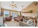 Comfortable living room with vaulted ceiling, ceiling fans, and ample natural light through french doors at 2843 Startown Rd, Lincolnton, NC 28092