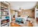 Bright main bedroom features a ceiling fan, light hardwood floors, and a sitting bench at 2843 Startown Rd, Lincolnton, NC 28092