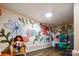 Basement playroom with fun floral mural, built-in kitchenette, and hardwood flooring at 2843 Startown Rd, Lincolnton, NC 28092