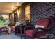 Relaxing front porch with comfortable wicker furniture and brick exterior at 2843 Startown Rd, Lincolnton, NC 28092