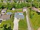 Aerial view of a home, highlighting the swimming pool, detached garage, and meticulously landscaped yard at 2908 Dylan Nw Pl, Concord, NC 28027