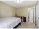 Cozy bedroom features neutral carpeting and adjacent bathroom access at 2908 Dylan Nw Pl, Concord, NC 28027