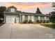 Charming home with a dormer window, an attached garage, and a well-manicured lawn at 2908 Dylan Nw Pl, Concord, NC 28027