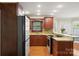 Well-lit kitchen with stainless steel appliances, granite countertops and hardwood floors at 2908 Dylan Nw Pl, Concord, NC 28027