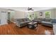 Cozy living room featuring hardwood floors, a large sofa, and a coffee table at 2908 Dylan Nw Pl, Concord, NC 28027