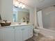 This bathroom offers white cabinets, great lighting, neutral tones, and a shower and tub combo at 300 W 5Th St # 723, Charlotte, NC 28202