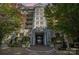 Elegant condo building entrance featuring stone columns, manicured landscaping, and a welcoming brick walkway at 300 W 5Th St # 723, Charlotte, NC 28202