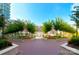 Beautifully landscaped courtyard with symmetrical walkways, vibrant flowerbeds, and mature shade trees at 300 W 5Th St # 723, Charlotte, NC 28202
