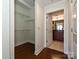 A hallway with a walk-in closet and an open door to a bathroom at 300 W 5Th St # 723, Charlotte, NC 28202
