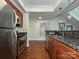 Gourmet kitchen with stainless steel appliances, granite counters, and wood floors at 300 W 5Th St # 723, Charlotte, NC 28202