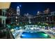 A serene pool area, lit up at night, surrounded by the beautiful skyline and community at 300 W 5Th St # 723, Charlotte, NC 28202