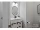 Stylish bathroom with a modern vanity, oval mirror, and sleek lighting at 3092 Riker St, Clover, SC 29710
