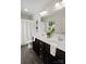 Bright bathroom with a double vanity, large mirror, white shower curtain, and dark cabinetry at 3092 Riker St, Clover, SC 29710