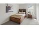 Charming bedroom featuring a rustic wood bed frame and a nightstand with a lamp at 3092 Riker St, Clover, SC 29710