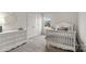 Cozy bedroom with a white crib, dresser, and soft carpet for a comfortable feel at 3092 Riker St, Clover, SC 29710