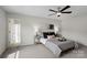 A serene bedroom featuring neutral decor, side tables with lamps, and an adjoining bathroom at 3092 Riker St, Clover, SC 29710
