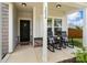Inviting front porch with cozy rocking chairs, a decorative wreath, and a welcoming entryway, perfect for relaxing at 3092 Riker St, Clover, SC 29710