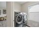 Modern laundry machines in a well-lit space with a nearby window at 3092 Riker St, Clover, SC 29710