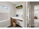 Convenient laundry area with folding counter, overhead shelving, and natural light at 3092 Riker St, Clover, SC 29710