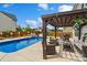 Backyard featuring a pristine pool, a wooden pergola, and comfortable outdoor seating, creating a relaxing oasis at 3092 Riker St, Clover, SC 29710