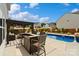 Outdoor pool area with bar, seating, and lush landscaping offers the perfect spot for entertaining guests at 3092 Riker St, Clover, SC 29710