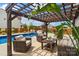 Backyard featuring a luxurious pool, a stylish pergola with seating, and lush greenery, creating a perfect outdoor retreat at 3092 Riker St, Clover, SC 29710