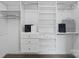 Organized walk-in closet with custom shelving and drawers for optimal storage at 3092 Riker St, Clover, SC 29710