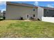 Large grassy backyard with a patio area featuring a picnic table and grill near a two-story home at 3113 Bouquet St, Charlotte, NC 28215