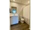 Well-lit bathroom featuring a white vanity, wood-look floors, and a shower with a patterned curtain at 3113 Bouquet St, Charlotte, NC 28215