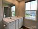 Bright bathroom featuring double sinks, a large mirror, and a window offering natural light at 3113 Bouquet St, Charlotte, NC 28215