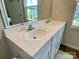 Bathroom vanity with dual sinks, a large mirror, and wood look vinyl flooring at 3113 Bouquet St, Charlotte, NC 28215