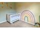 View of cozy Bedroom with crib and whimsical rainbow wall art creating an inviting space at 3113 Bouquet St, Charlotte, NC 28215