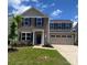 Charming two-story home featuring a well-maintained lawn and a two-car garage at 3113 Bouquet St, Charlotte, NC 28215