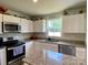 Eat-in kitchen features stainless appliances, modern cabinets, and granite countertops at 3113 Bouquet St, Charlotte, NC 28215