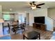 Bright living room with dining area, featuring wood floors and a large flat screen television at 3113 Bouquet St, Charlotte, NC 28215