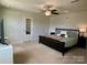 Main bedroom featuring a ceiling fan, neutral walls, carpet, and bedside tables at 3113 Bouquet St, Charlotte, NC 28215