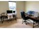 Bright office space featuring dual workstations, modern tech setups and natural light at 3113 Bouquet St, Charlotte, NC 28215